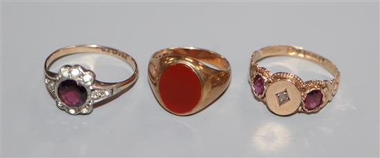 A 9ct gold signet ring with carnelian matrix, a 9ct diamond and amethyst gypsy-set ring and a 9ct garnet ring.